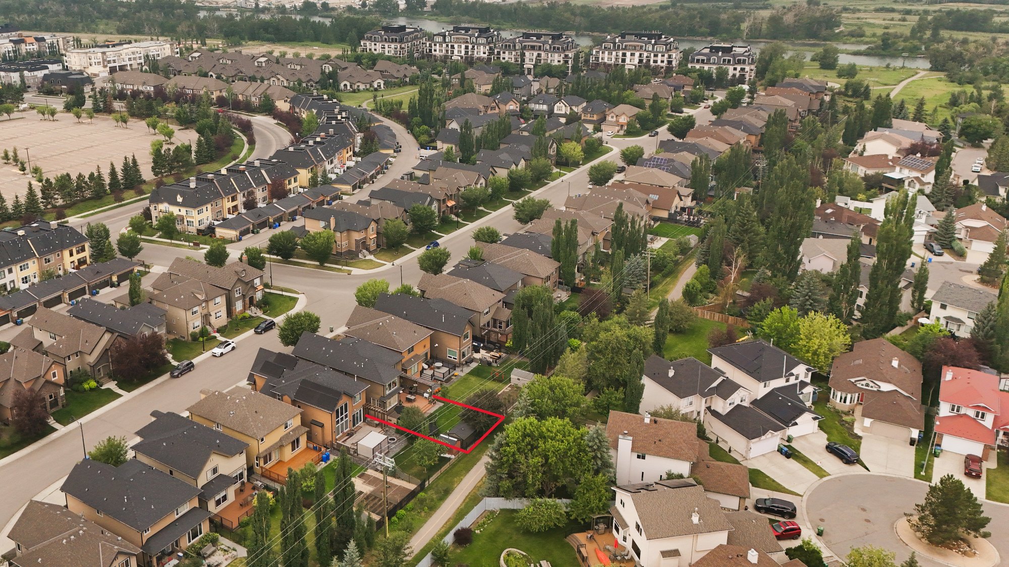 Aerial of the neighbourhood with the property outlined, the Bow River beyond